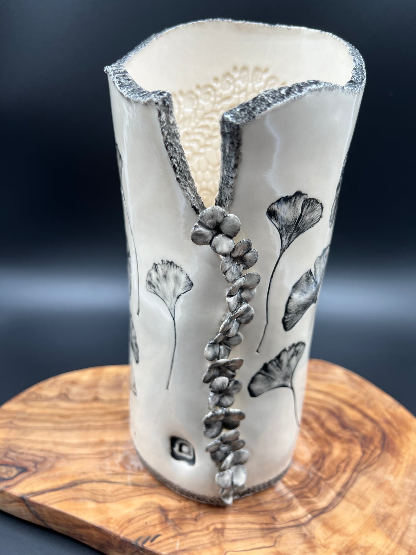 Black gingko vase, black rim, cascading flowers