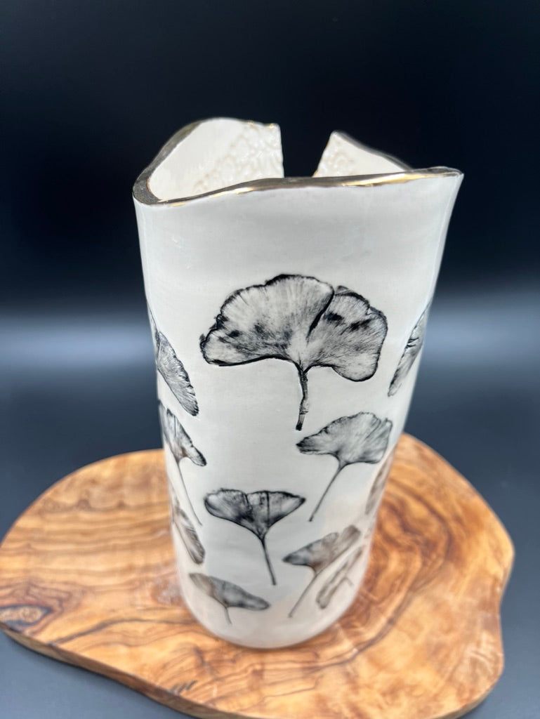 Black floral vase, gold rim, cascading flowers
