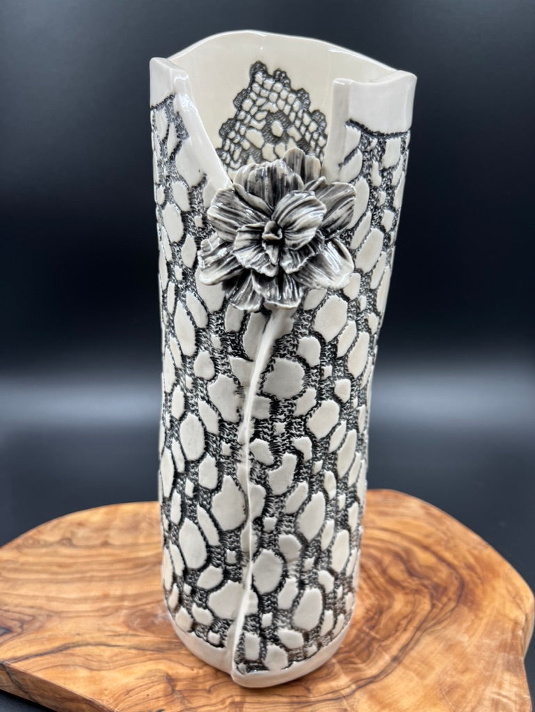 Black lace vase with flower at lip and black interior lace, tall