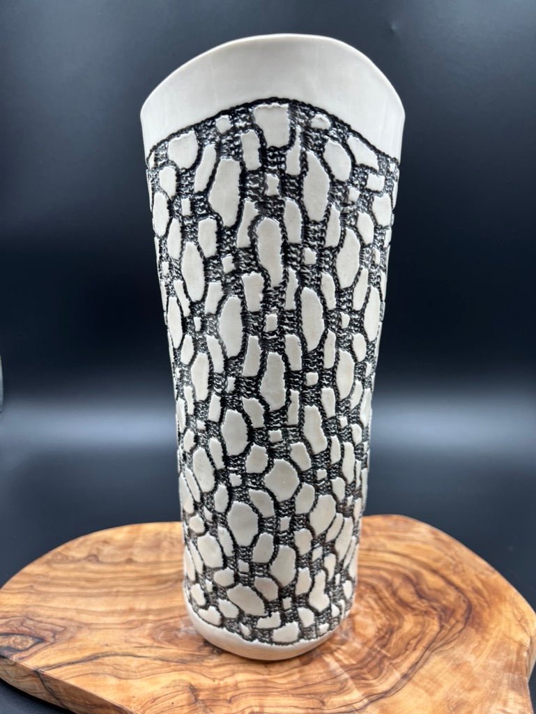 Black lace vase with flower at lip and black interior lace, tall