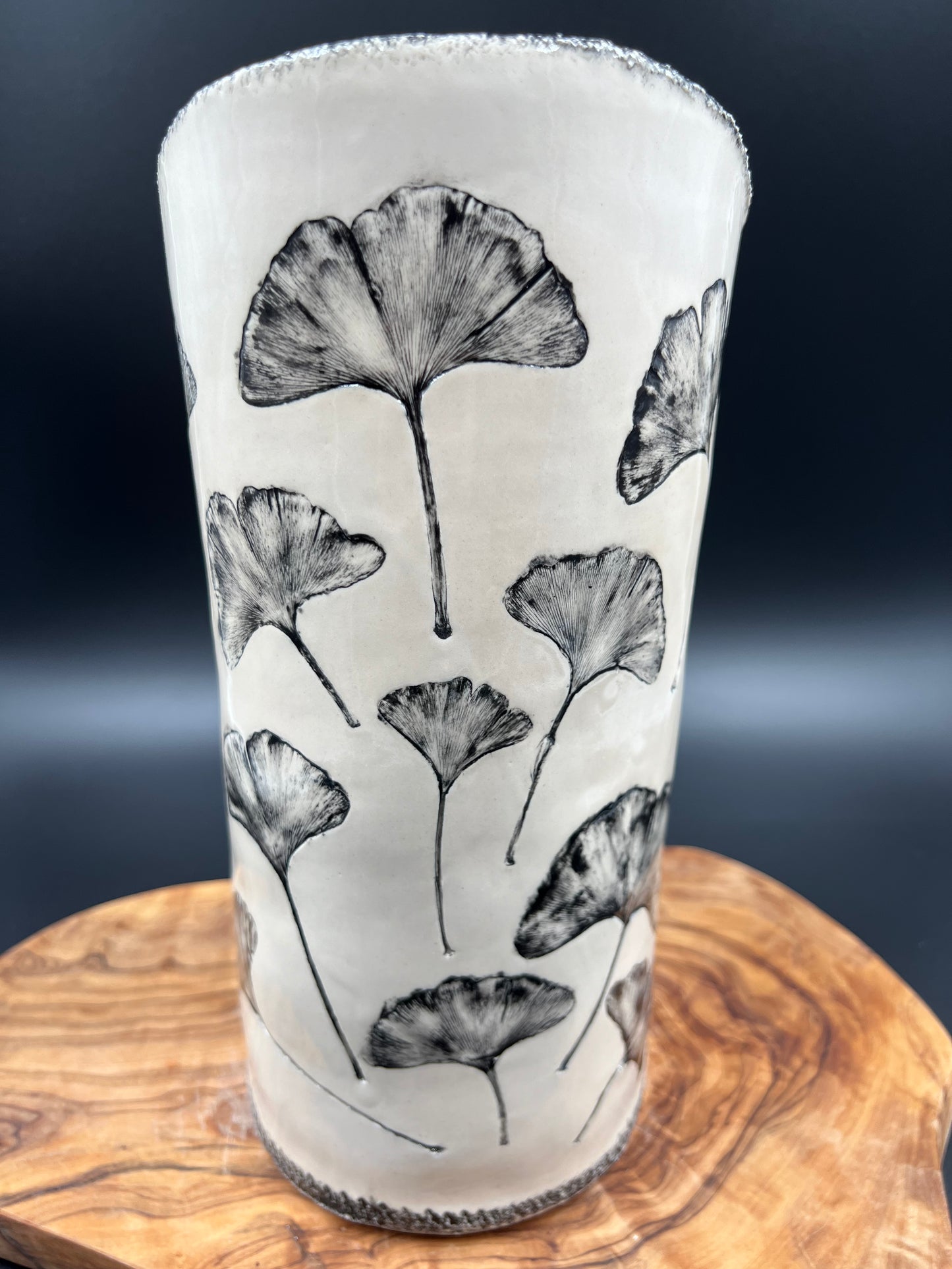 Black gingko vase, black rim, cascading flowers