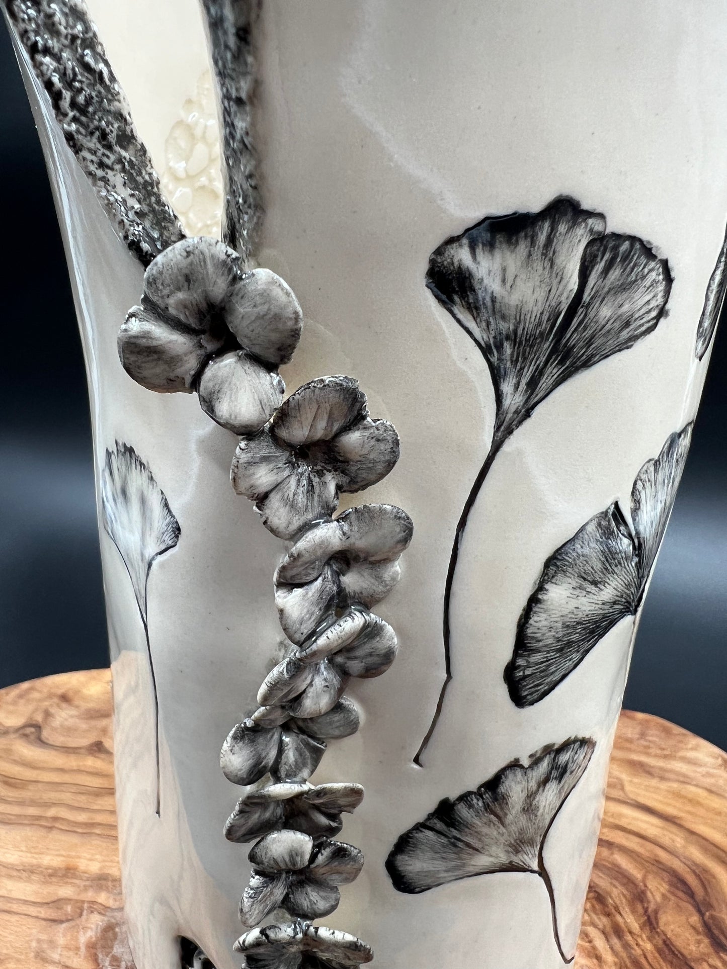 Black gingko vase, black rim, cascading flowers