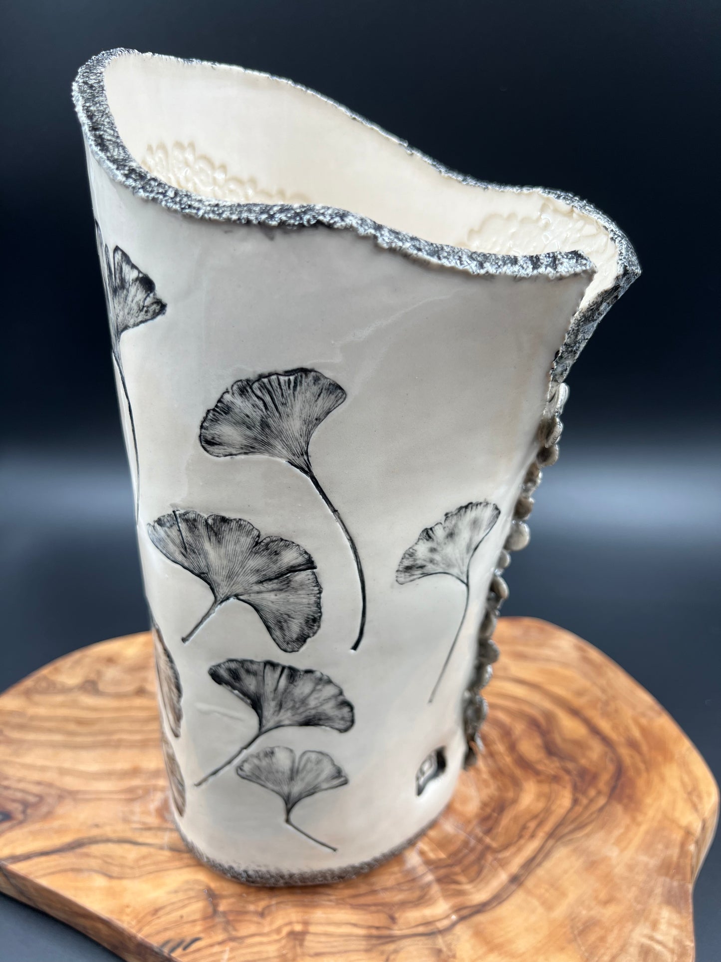 Black gingko vase, black rim, cascading flowers