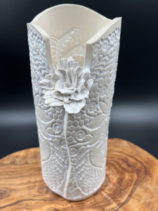 Cream lace vase with flower at lip